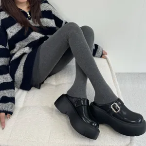 Detailed view of women winter thick opaque pantyhose tights paired with platform shoes.