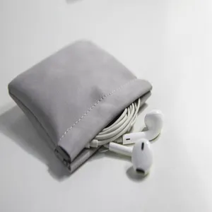 Gray leather spring pouch for earphones and data cables, portable mini storage bag detail.