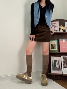 Detailed lifestyle view of slouchy brown leg warmers styled with autumn outfits.