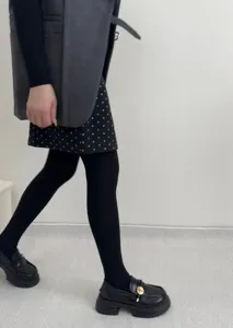Detailed view of women knitted tights in winter, showcasing cable texture and stretchy fit.