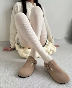 Detail view of retro cable knit tights, cozy winter ribbed pantyhose in off-white grey tone for daily wear.