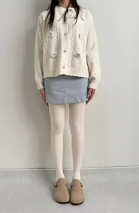 Detailed view of women's vintage cable knit tights, cozy winter ribbed hosiery for daily wear.