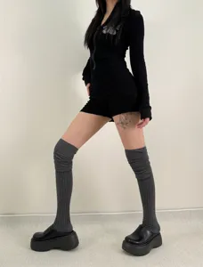 Detailed view of the stylish grey over-the-knee ribbed stack socks, perfect for autumn outfits.
