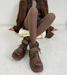 Close-up detail of retro brown cable knit tights, soft winter thermal texture pantyhose.