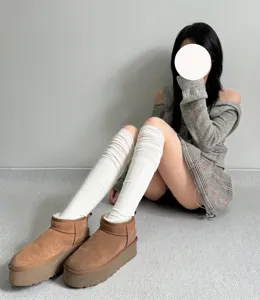 Detailed view of cozy over-the-knee white stacked socks paired with stylish platform boots.