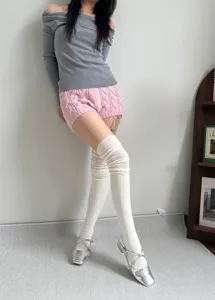 Detailed view of white slouchy over-the-knee socks, perfect for cozy daily autumn winter outfits.
