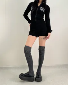 Detail view of cozy grey over-the-knee knit stack socks paired with stylish outfit.