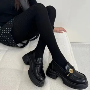 Retro black ribbed knit tights and chunky heel loafers set, stylish autumn winter footwear look.
