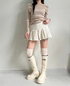 Detailed view of slouchy over-the-knee knit socks paired with trendy platform boots.