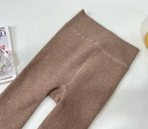 Brown winter thick fleece-lined thermal leggings, high-waisted ribbed design, warm fabric detail.