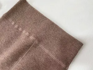 Detailed shot of thick warm brown fleece lined thermal tights ribbed waistband for winter fashion.