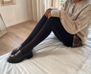 Detailed view of warm fleece-lined brown thermal winter tights worn comfortably indoors.