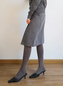 Autumn winter grey fleece lined tights skirt outfit detail, cozy comfortable apparel styling.