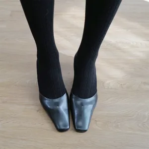 Women's black textured tights paired with classic square toe leather shoes for autumn winter.