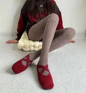 Collants en tricot douillets associés à des chaussures plates rouges pour l'automne.
