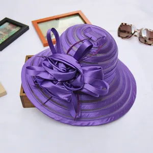 Close-up detail of the purple organza sun hat, showing delicate flower bow and fabric texture.