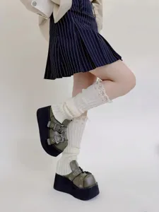 Knitted leg warmers for women, distressed vintage style winter socks and cozy leg covers.