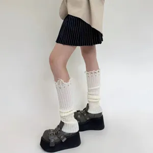 Detailed close-up shot of distressed knitted leg warmers showing the unique fringe and holes.