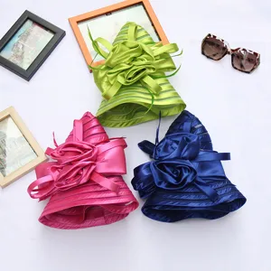 Detailed view of women crystal organza fascinator sun hats with floral decor in multi colors.