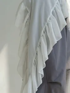 Close-up detail of white chiffon layered ruffle dance hip scarf showing sheer fabric texture.