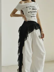 Stylish off-shoulder t-shirt with loose casual trousers and sheer black waist skirt set for women.