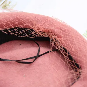 Pink wool beret detail featuring elegant mesh veil and classic retro painter hat design.