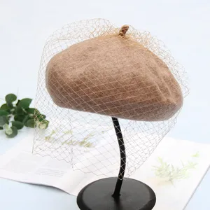 Detailed view of women autumn winter woolen beret hat with elegant mesh veil retro style.
