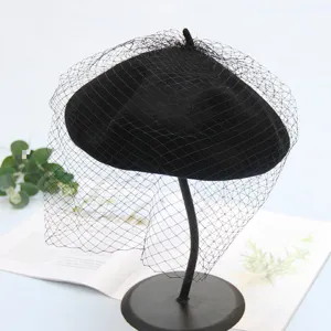 Black woolen beret with elegant mesh veil, retro vintage style hat for autumn and winter.