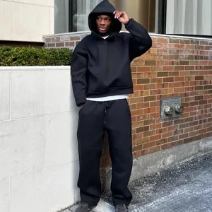 Detail shot of the black hoodie and sweatpants set, featuring a relaxed fit and soft fabric.