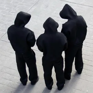 Detailed view of casual black oversized matching hoodie and sweatpants set for streetwear.