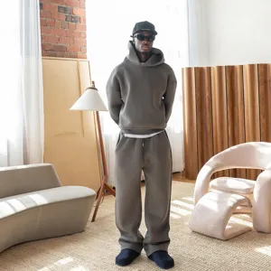 Oversized hoodie and sweatpants set in solid taupe, comfortable streetwear fashion style.