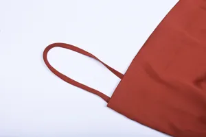 Detailed view of the elegant women's slip dress strap, featuring soft rust red fabric.