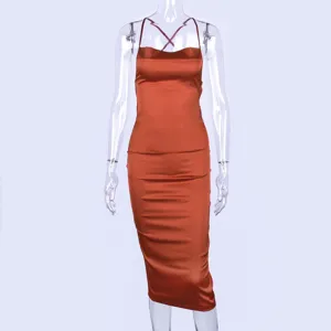 Detail shot of the elegant satin slip dress, smooth fabric texture and slim midi cut.