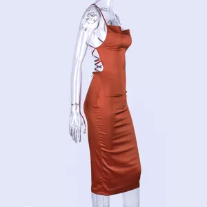 Detailed view of French satin slip midi dress in burnt orange with backless strap design.