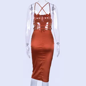 Back view detail of a chic satin midi slip dress featuring a stunning backless criss-cross strap design.