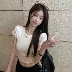 Close up detail view of casual solid white crop top short sleeve slim fit summer tee.