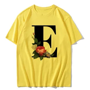 Yellow short sleeve t-shirt featuring a large black letter E and vintage floral print.