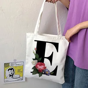 Borsa shopper in tela con lettera E nera e stampa floreale, comoda borsa casual.