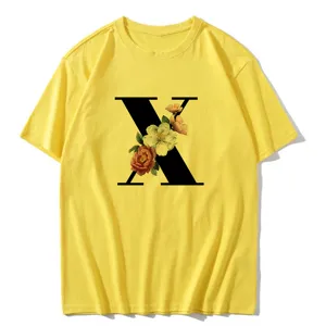 Yellow short sleeve t-shirt with black letter X and floral print, casual women's summer top.