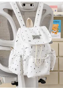 Detailaufnahme eines süßen Polka-Dot-Rucksacks mit Vordertaschen und praktischen Seitentaschen.