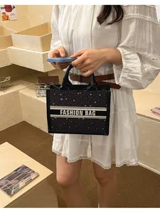 Black canvas embroidered star pattern top handle tote bag for women stylish daily use.