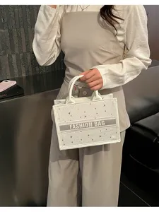 Stylish white canvas tote bag with star patterns and center stripe for women daily use.