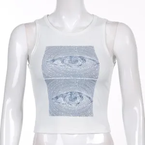 Detail view of a trendy white crop tank top featuring a unique blue eye graphic print.