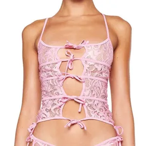 Pink lace front-tie cutout camisole detail shot showing exquisite jacquard texture and bows.