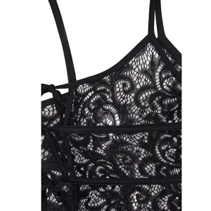 Close-up detail of black lace camisole featuring delicate floral patterns and straps.