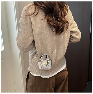Mini metallische silberne Umhängetasche mit schicker Kette und süßem Schloss-Anhänger.