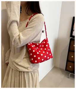 Detailed view of the red polka dot underarm shoulder bag, showcasing stylish everyday style.