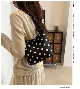 Detailed view of a chic black and white polka dot shoulder bag, stylish casual accessory.