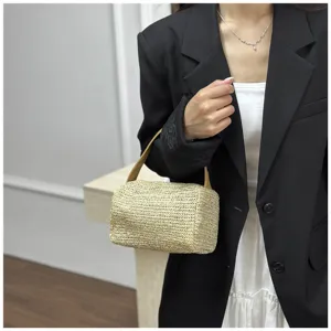 Woven straw handbag detail view highlighting texture and handle in a modern indoor scene.