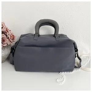 Detailed view of the large capacity grey sports duffel bag for fitness, yoga and travel.